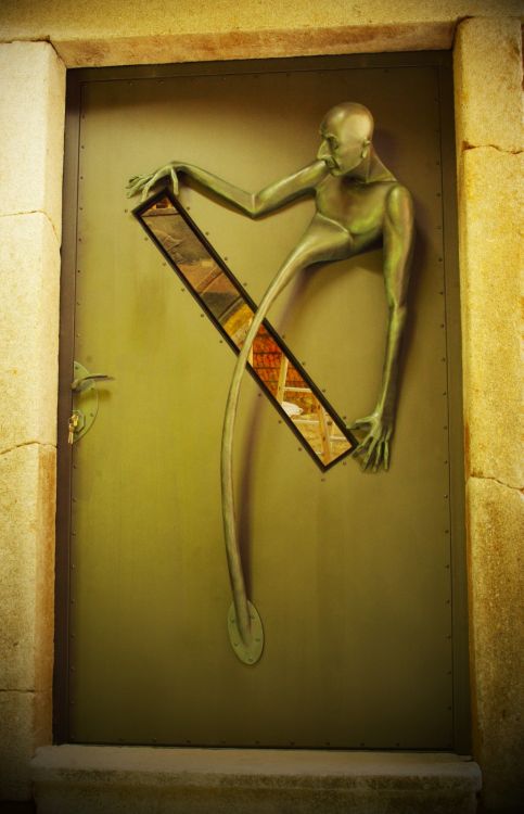 Metal forged door with figural sculpture (2017).